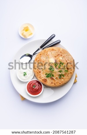 Aloo paratha or gobi paratha also known as Potato or Cauliflower stuffed flatbread dish originating from the Indian subcontinent Royalty-Free Stock Photo #2087561287