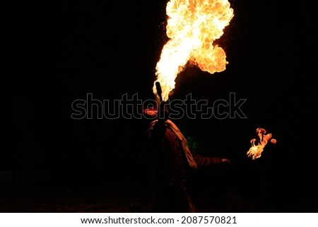 Fires how, man fakir splits fire, dragon's breath. Selective focus. High quality photo