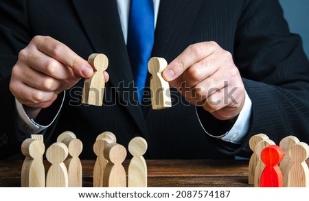 A businessman evaluates candidates for employment. Staff and Human Resource Management. Team building. Employment. Personnel selection. Staffing, recruiting and training workers. Appointment to posts Royalty-Free Stock Photo #2087574187