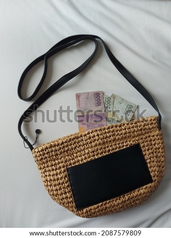 knitting or crocheting summer bag lying on white bed sheet. summer holiday concept. Minimalist and aesthetic photography. Isolated background
