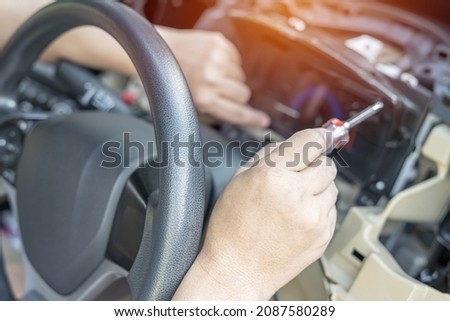 Close up hand Technician use screw driver remove and check car speedometer with check the point of damage and check for repair work in car service shop