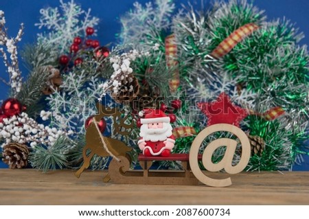 Happy new year - sign e-mail,  with Christmas decorations on wooden table, front view, copy space. Christmas delivery letter