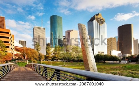 ooden bridge in Buffalo Bayou Park, with a beautiful view of downtown Houston (skyline  skyscrapers) in background on a summer day - Houston, Texas, USA Royalty-Free Stock Photo #2087601040