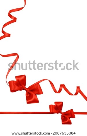 Holiday greeting card or invitation with copy space and place for text. Red satin ribbon and bow isolated on white background. Festive design element. Christmas ornaments.