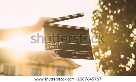 film slate on women's hands in the sunset.Storytelling and New Age Filming industry concept.