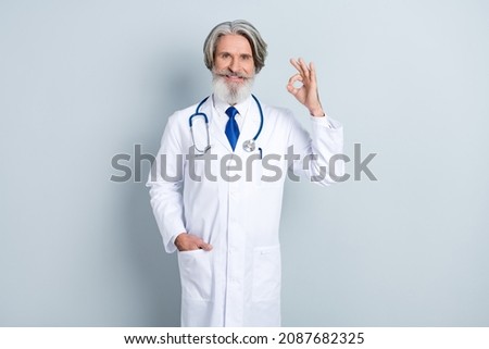 Photo of cardiologist man show okey symbol advertise cov protection vaccine injection immunity isolated over grey color background