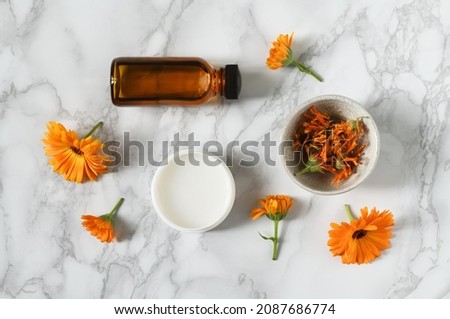 Arrangement of skin care products with calendula flowers