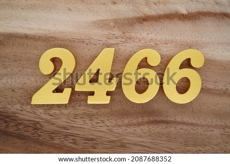 Golden Arabic numerals 2466 on a dark brown to white wood grain background.