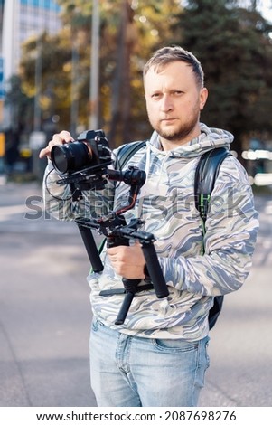 Professional videographer with gimball equipment setup before shooting. He is ready for video work