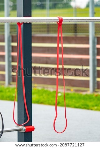 Workout gym with horizon bars with elastic exercise band.  School outdoor gym