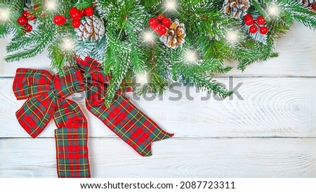  red Christmas bows on a white wooden background banner. Christmas background, photo for a postcard or gift bag