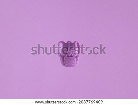 Purple backpack, isolated against pastel background. Minimal holiday layout. 