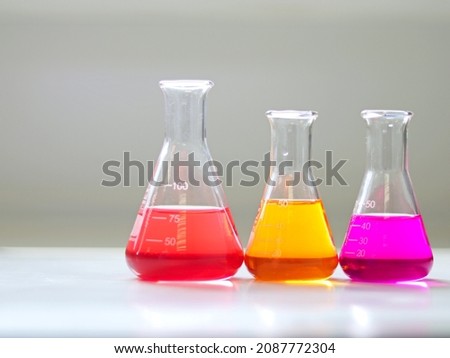 The Erlenmeyer or Conical flask on bench laboratory, with colorful solvent solution from titration experiment. Parameter of acidity and alkalinity, acid-base analysis compounding in wastewater sample. Royalty-Free Stock Photo #2087772304