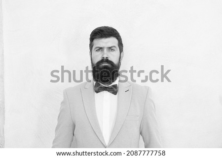 male fashion and beauty. handsome man has unshaven face. skilled sommelier. bride groom on wedding day. event host wear bow tie. adult hipster man in stylish tuxedo