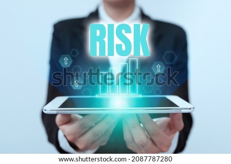 Hand writing sign Risk. Word for Possibility of losing something of value or threat of damage Lady In Uniform Holding Touchpad Showing Futuristic Virtual Interface.