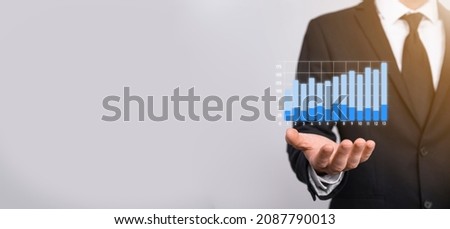 Businessman holding graph growth and increase of chart positive indicators in his business.Investment up concept.analyzing sales data and economic,strategy and planning, Digital marketing and stock