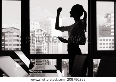 Successful business woman with arm up.