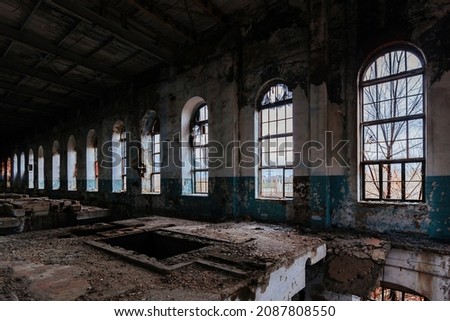 Wall with vaulted windows in abandoned and ruined sugar factory.