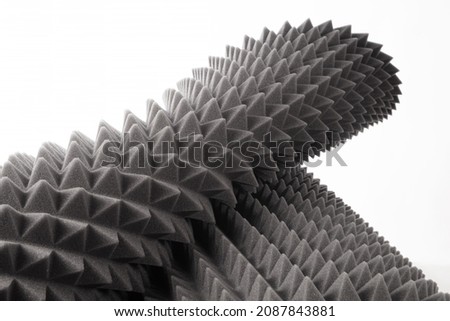 Studio sound proof foam pattern texture. Dark gray triangular acoustic foam rubber on a white background.  Shallow depth of field Royalty-Free Stock Photo #2087843881