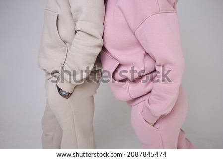 Girl in stylish, cozy sportswear against a bright background, studio shooting for a magazine, details of fabrics and flowers