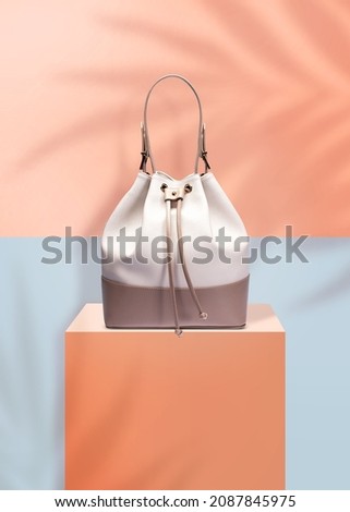 Fashion handbag isolated on a purple shiny background with clipping mask