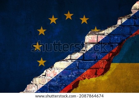 cracked concrete wall with flag of  Ukraine, Russia,  EU europe union  texture - concept for relations between countries, war troops  Border Crisis, agreement, conflict, political tension Royalty-Free Stock Photo #2087864674