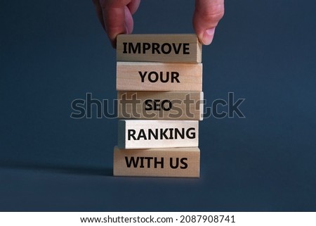 Improve your SEO ranking with us symbol. Wooden blocks with words Improve your SEO ranking with us. Businessman hand. Beautiful grey background, copy space. Business, improve SEO ranking concept. Royalty-Free Stock Photo #2087908741