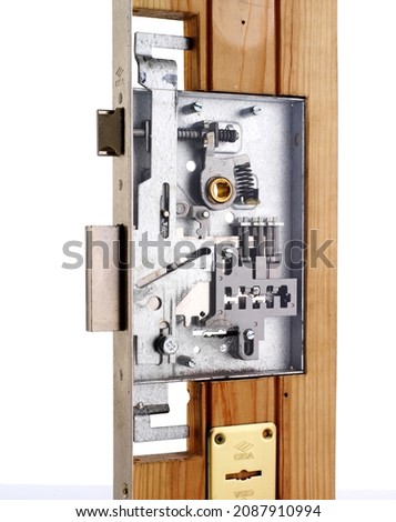 Internal mechanism of metal mortise lock with latch and deadbolt cut into edge of door isolated on white background Royalty-Free Stock Photo #2087910994