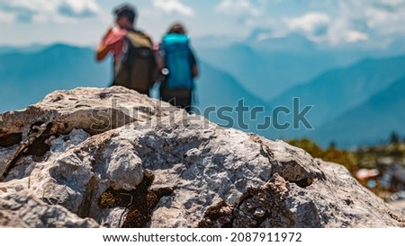 Beautiful alpine summer view with details of a rock and hikers in the background at the famous Loser summit, Altaussee, Steiermark, Austria