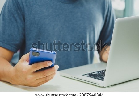 Men using mobile and computers are working on searching for information using internet technology.Modern concepts, business communication, investment and online marketing.