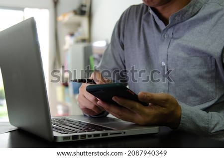 Businessman using mobile and computers are working on searching for information using internet technology.Modern concepts, business communication, investment and online marketing.