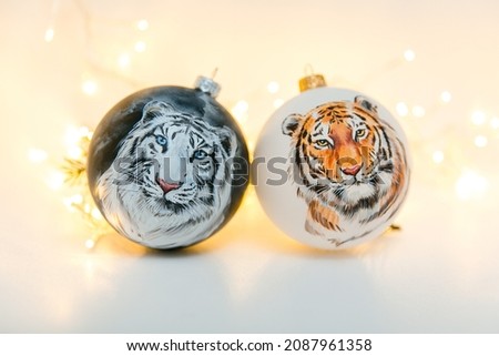 
christmas ball with a picture of a tiger on a white background with a garland