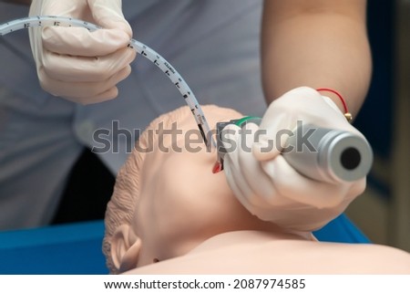 Anesthesiologist performing an orotracheal intubation on a simulation, Medical manipulation. mannequin dummy during medical training to control of the airway. Royalty-Free Stock Photo #2087974585