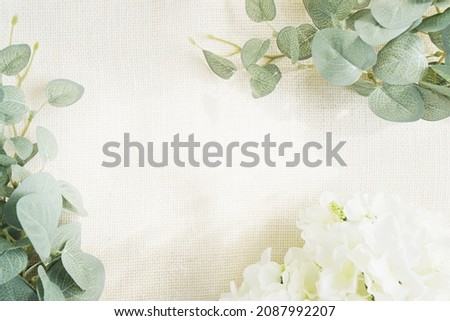 top view, flat lay style of table setting mock up with white sackclot and decor green branches eucalyptus with copy space. background for wallpaper, design, lettering, cards, blogs, banner or poster.