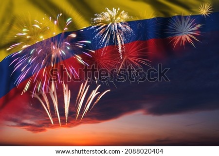 Majestic fireworks in evening sky and flag of Colombia for Independence day or National Holiday Royalty-Free Stock Photo #2088020404