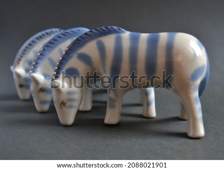 Porcelain figurines of Zebra on a dark gray background. Blue and white. Vintage.