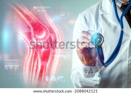 Joint pain, the doctor looks at the hologram of the knee joint. X-ray image, trauma, rheumatologist consultation, skeletal image, medical concept, medical technologies of the future Royalty-Free Stock Photo #2088042121
