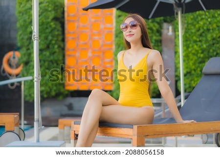 Portrait beautiful young asian woman relax smile leisure around outdoor swimming pool in holiday vacation travel trips