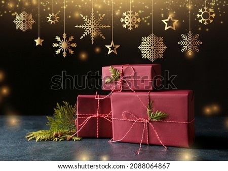 Stylish Christmas gifts on dark background