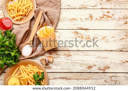 Tasty french fries with sauces on table
