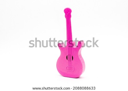Toy guitar on white background with selective focus