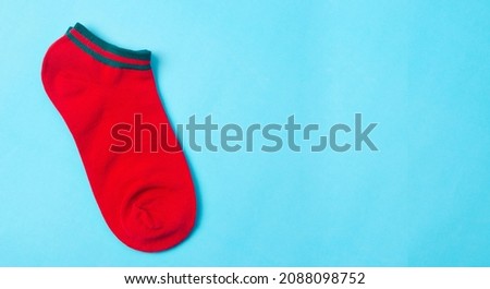Red socks on blue background and space for text.