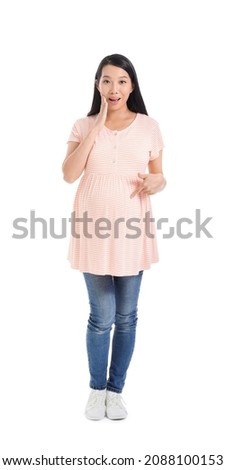 Surprised pregnant Asian woman on white background