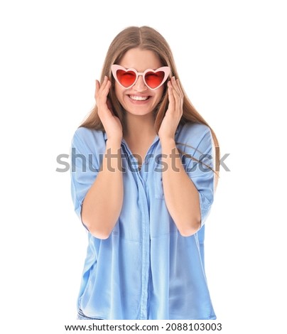 Beautiful young woman in stylish heart-shaped sunglasses on white background