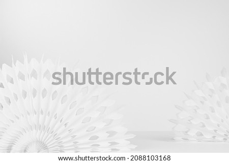 White abstract scene for presentation of produce with circle paper carved white fans on table in minimal simple modern asian style, copy space, closeup.