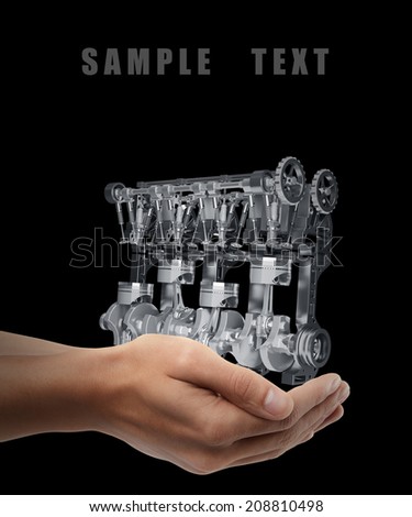 Car engine. Man hand holding object  isolated on black background. High resolution 