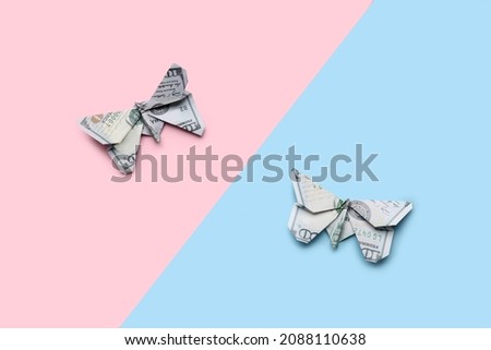 Origami butterflies made of dollar banknotes on color background
