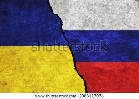 Concept of a conflict between Russia and Ukraine with painted flags on a wall with a crack Royalty-Free Stock Photo #2088117076