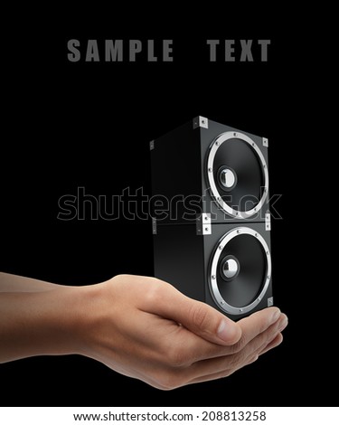 black speakers. Man hand holding object  isolated on black background. High resolution 