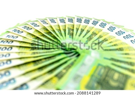 Macro photo of the European Union 100 EURO banknote, bills arranged in a fan, isolated on a white background, selective focus.